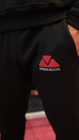 Close-up of black Moreno Boxing joggers with red logo detail
